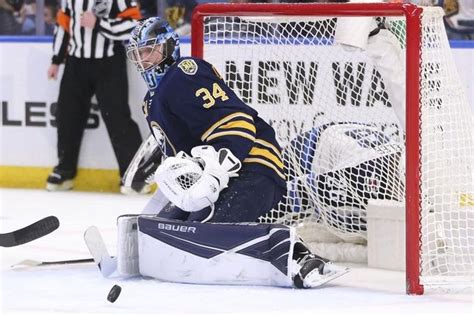 the hockey goalie is getting ready to make a save