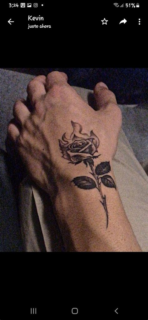 A Person With A Rose Tattoo On Their Arm