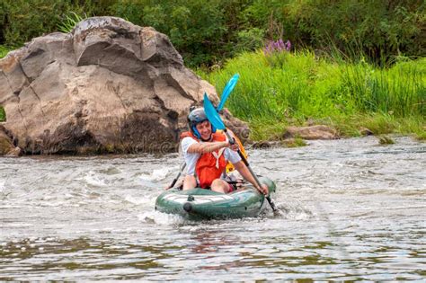 Rafting Trip. Two Rowers are Rafting Down the River in a Rubber ...