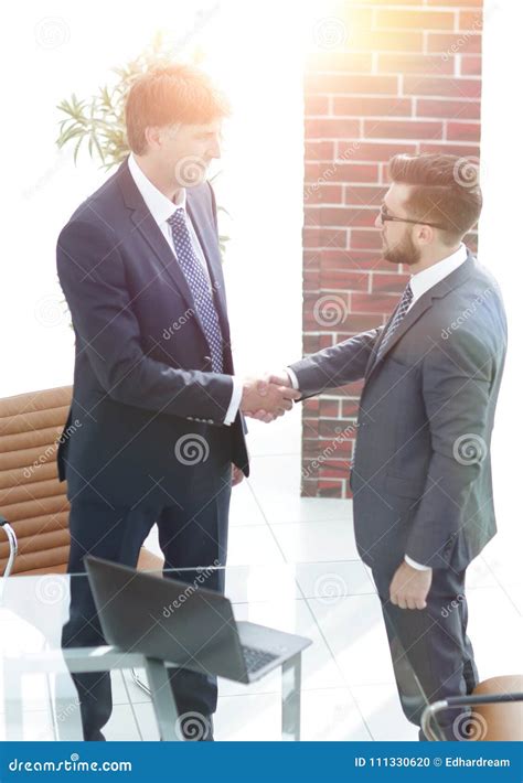 Two Businessmen Shaking Hands In Office Stock Photo Image Of