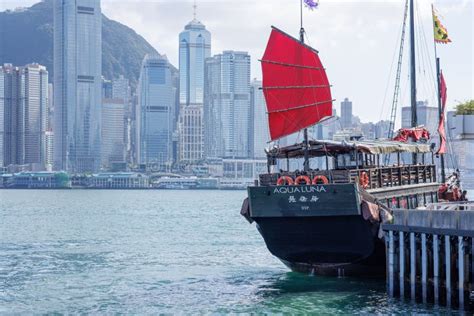 Aqua Luna Junk Boat Crossing Near The Victoria Harbour On Hong Kong