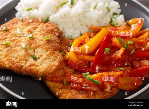 Closeup Of Delicious Fried Breaded Meat Gypsy Schnitzel With Spicy Pepper Sauce Served With Rice