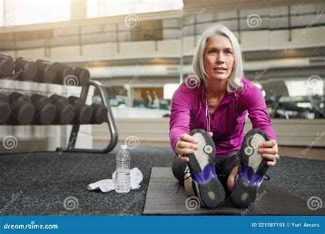 Mature Woman Warm Up And Legs On Gym Floor Stretching And Challenge For Progress In Workout