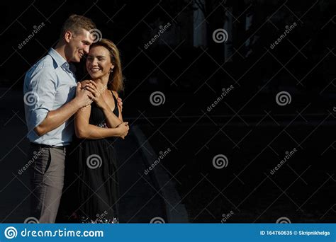 Happy Loving Couple Hugging Guy Kisses A Girl And Hugs From Behind