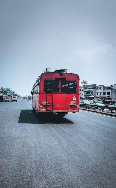 Un Autob S Rojo Circula Por Una Carretera Con Un Letrero Que Dice