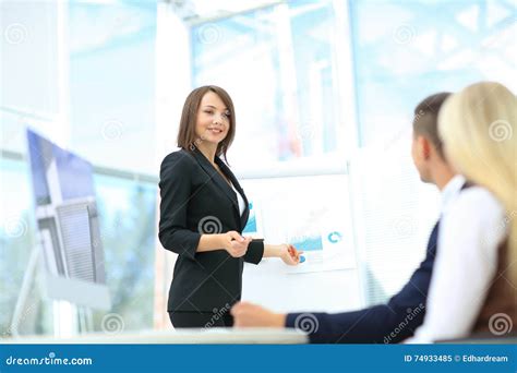 Businesswoman Asking Question During Her Colleagues Presentation Stock