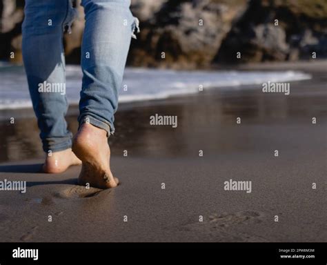 man walking barefoot on the beach Stock Photo - Alamy