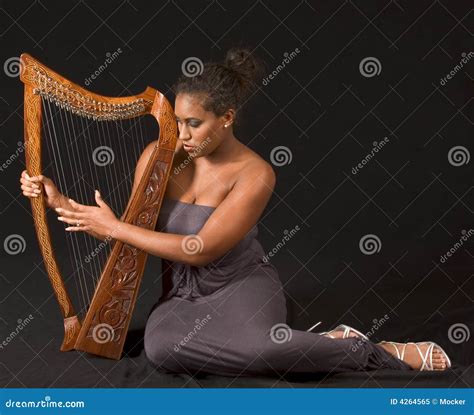 African American Woman Playing With Harp Royalty Free Stock Photo