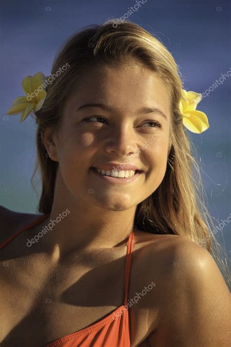 Portrait Of A Teenage Girl With Plumeria In Her Hair Stock Photo