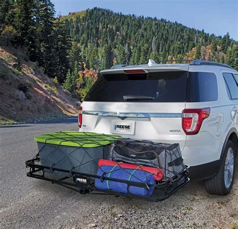 The Back End Of A White Suv With Luggage Strapped To Its Cargo Bag