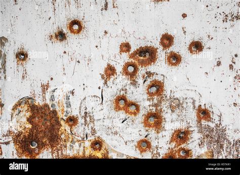 Texture Of Old Rusty Metal Sheet With Bullet Holes On It Stock Photo