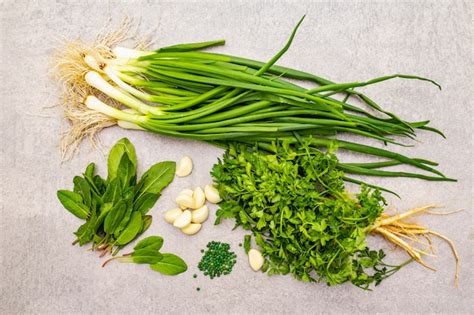 Premium Photo Fresh Greens On A Stone Table Top View