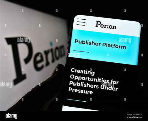 Person holding cellphone with webpage of Israeli company Perion Network ...