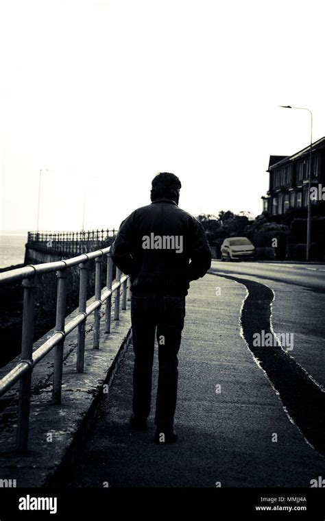 black and white image of male silhouette walking away Stock Photo - Alamy