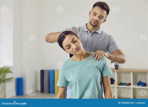 Chiropractor Osteopath Or Manual Therapist Helping Young Patient Who