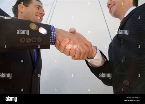 Two Businessmen Shaking Hands Stock Photo Alamy