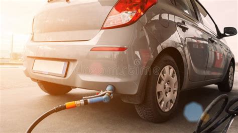 Pumping Gas Fuel Car At Oil Station Woman Hand Refuel Petrol Nozzle