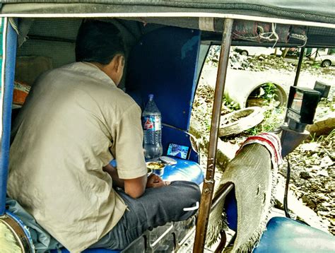 Stock Pictures: Tech savvy Indian Rickshaw Driver