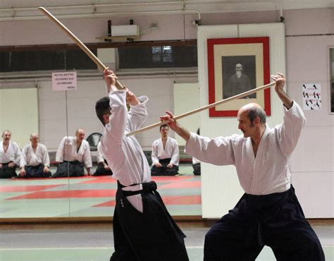 Download Aikido Master Practicing With Jo Staff In Traditional Dojo