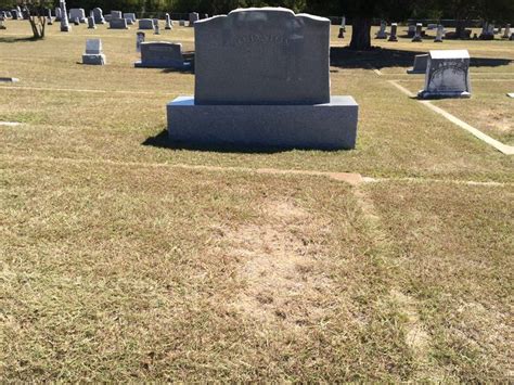 The Headstones Of Several Different Graves In A Cemetery Area With