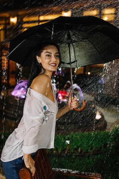 Premium Photo Cheerful Pretty Girl Holding Umbrella While Strolling