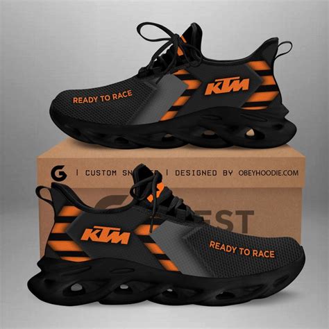 A Pair Of Black And Orange Sneakers On Top Of A Cardboard Box With The