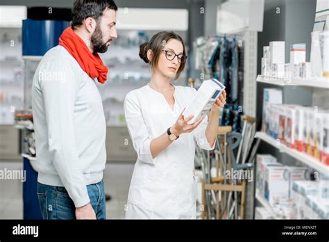 Pharmacist With Client In The Pharmacy Store Stock Photo Alamy