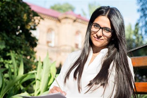 Portrait Of A Beautiful Indian Girl Business Woman In Glasses Sits On