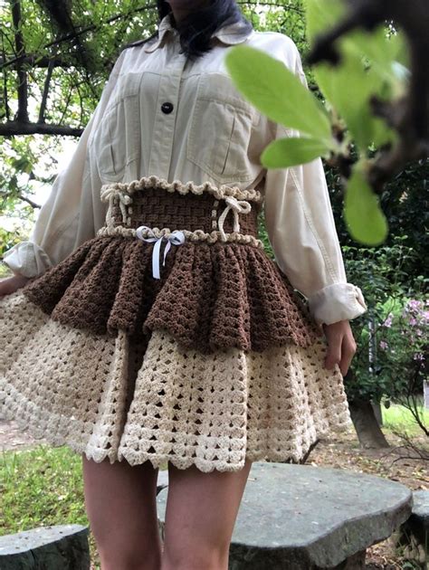 A Woman Is Wearing A Crocheted Skirt And Boots