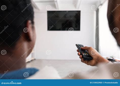 Black Couple Watching Tv With Mockup And Using Remote Controller Stock