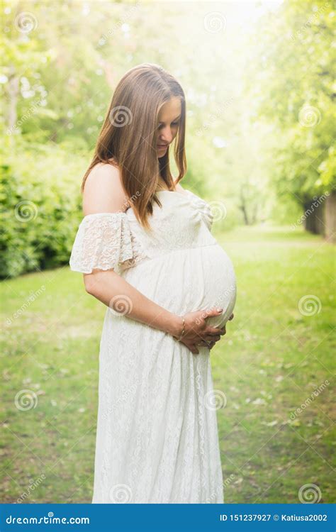 Happy Pregnant Woman Posing Over Green Natural Background Stock Image