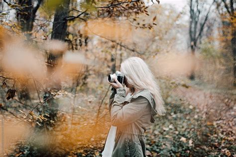 Blonde Woman Taking Picture With Camera In Nature By Stocksy Contributor Boris Jovanovic