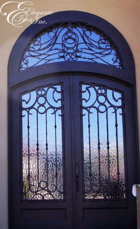 Custom Wrought Iron Door With Eyebrow Arch And An Attached Full Arch Transom Puertas De