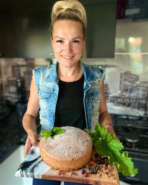 A Woman Holding A Plate With A Doughnut On It And Lettuce In Front Of Her