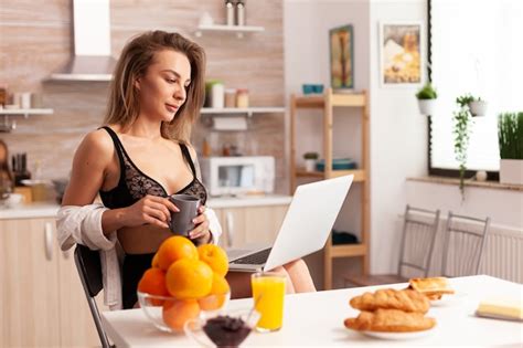 Premium Photo Sexy Woman Relaxing In Home Kitchen Wearing Lingerie Using Laptop Attractive