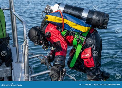 A Scuba Diver Climbing The Ladder Up To A Dive Boat Blue Ocean In The