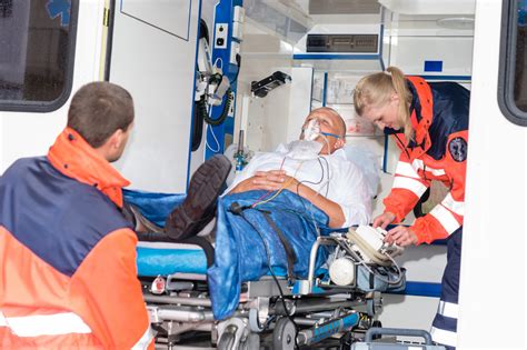 Paramedics Putting Patient Man Oxygen Mask In Ambulance Car Royalty