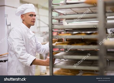 Focused Baker Uniform Carrying Tray Rack Stock Photo