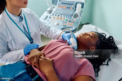 Black Woman During Ultrasound Diagnostics Of Endocrine System And