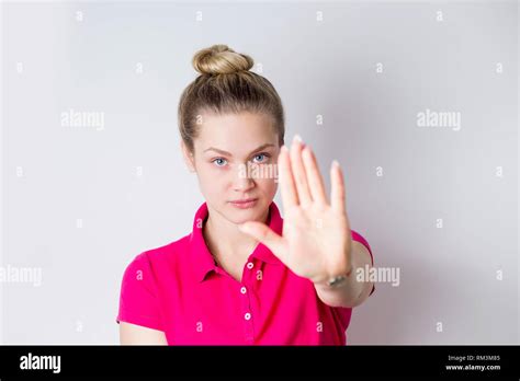 Portrait Of A Serious Young Womanin In Pink Dress Standing With