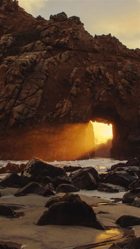 Sunset Glowing Through Rock Formation On Pfeiffer Beach Big Sur