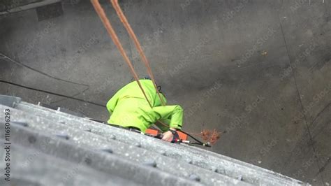 Unrecognisable Window Cleaner Works On High Rise Building Window