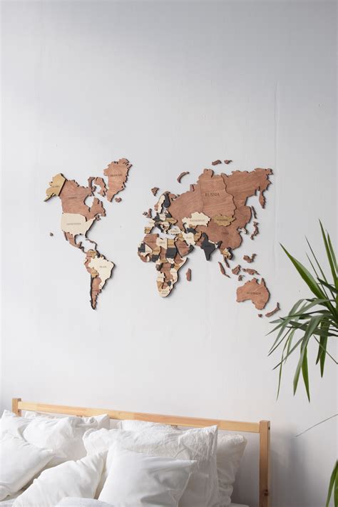 a bedroom with a bed and a wooden world map on the wall