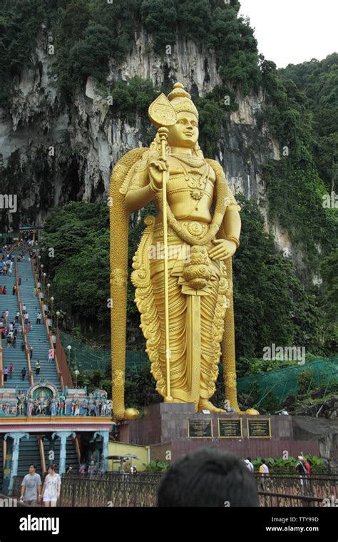 Golden Statue Of Lord Murugan At The Entrance Of Cave Batu Caves