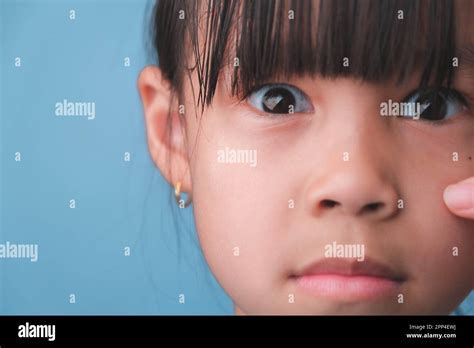 Close Up Portrait Of Surprised Young Asian Girl Isolated On Blue