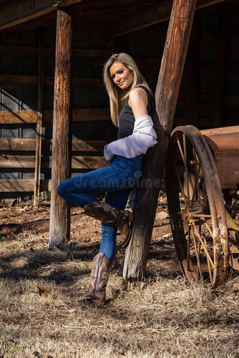 Lovely Blonde Model In Western Gear Poses Outdoor While Enjoying The Spring Weather Stock Image
