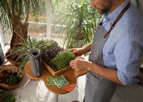 Free Photo | Man cultivating and farming plants in an indoor garden