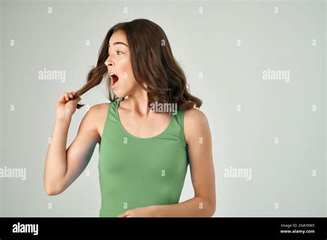 Pretty Brunette With Open Mouth In Green Tank Top Emotions Cropped View Stock Photo Alamy