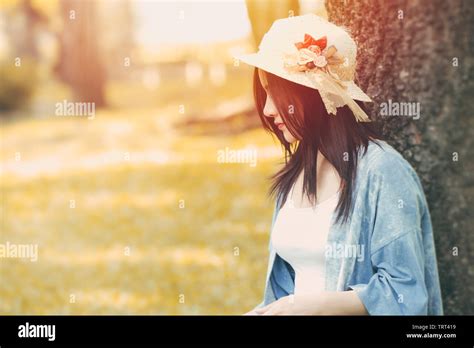 Beautiful Girl Sitting Under The Tree Alone In The Park Outdoor Summer