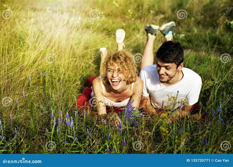 Young Loving Couple Enjoying Nature Holding Hands And Walking On The